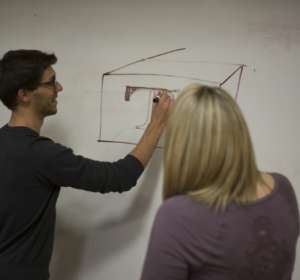 Students map out a problem on the whiteboard.